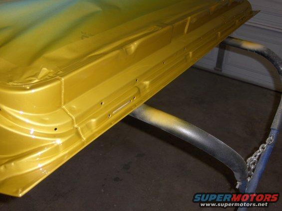 Yellow car door on a paint stand