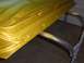 1971 Chevrolet Camaro - A car door, painted in a metallic yellow and blue gradient, rests on a stand in a workshop.