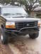 1994 Ford Bronco - This truck features a heavy-duty aftermarket bumper with a winch mount, suggesting off-road modifications.