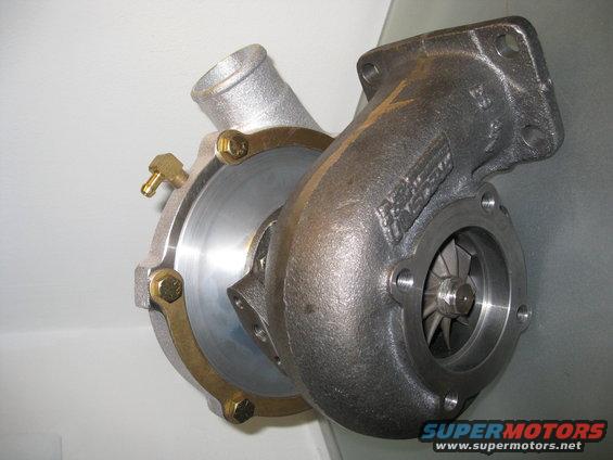 Turbocharger with silver and cast iron housings, showing compressor wheel