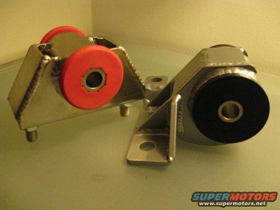 Two aftermarket engine mounts, one with red bushings, one with black