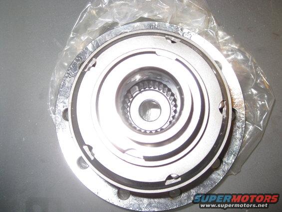Close-up of a metal automotive part, possibly a hub or differential component, with splines visible in the center