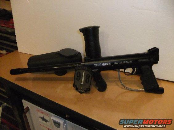 Black Tippmann 98 Custom paintball gun with hopper and a patch
