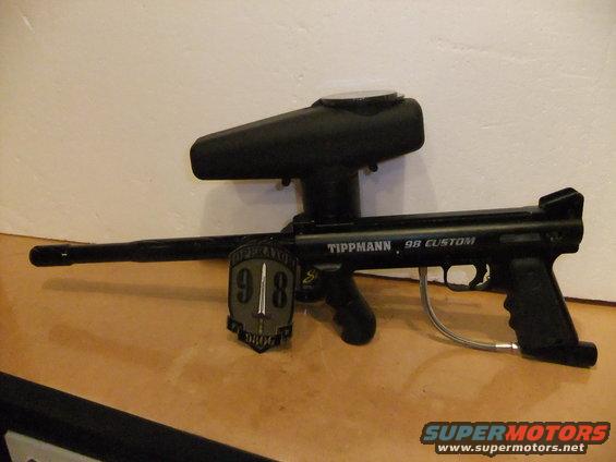 Tippmann 98 Custom paintball gun with hopper and a shield emblem