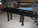 1994 Ford Bronco - A black metal rack with legs is shown in a garage setting.