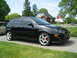 2003 Ford Focus - A black 2003 Ford Focus hatchback is seen from a three-quarter front view, parked on a residential street.