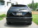 2003 Ford Focus - The rear of a black 2003 Ford Focus SVT hatchback is shown parked in a driveway.