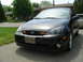 2003 Ford Focus - Front view of a black 2003 Ford Focus sedan parked on a residential street.