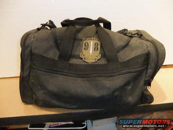 Black duffel bag with 'OPERATOR 918 98OG' patch