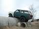 1989 Ford Bronco - This 1989 Ford Bronco navigates a challenging off-road course, climbing over large concrete pipes.