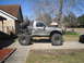 1984 Ford Bronco II - This heavily modified pickup truck features oversized tires and a custom roll cage with a spare tire mounted at the rear.