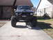 1984 Ford Bronco II - Modified 1984 Ford Bronco II sits in a driveway, equipped for off-road use with large tires and a custom bumper.