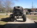 1984 Ford Bronco II - This custom buggy has a roll cage and large off-road tires, with a second vehicle visible in the driveway.