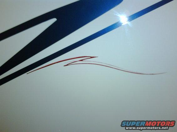 White truck side with blue graphic and red pinstripe
