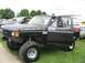 1986 Ford Bronco - Modified 1986 Ford Bronco with large off-road tires and custom decals seen at a truck show.