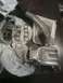 1987 Mazda RX-7 - Various engine parts, including an intake manifold and gaskets, laid out on a table.