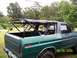 1979 Ford Bronco - Green 1979 Ford Bronco with its soft top removed, seen from the rear quarter angle.