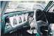 1979 Ford Bronco - The dashboard of a vehicle is shown with the instrument cluster disassembled, revealing wiring and components.