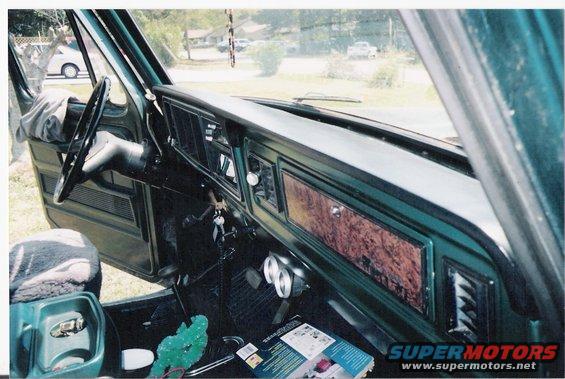 Green 1978 Ford Bronco interior showing dashboard, steering wheel, and door panel