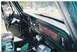 1979 Ford Bronco - The interior of a green 1978 Ford Bronco, viewed from the passenger side, reveals the dashboard and steering wheel.