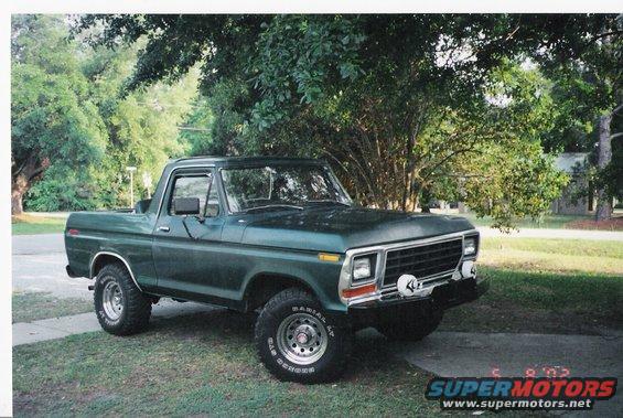 Green Ford Bronco parked outside on a sunny day