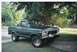 1979 Ford Bronco - This green Ford Bronco is parked on a driveway with trees and grass in the background.