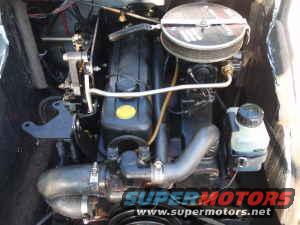 Close-up of a boat engine with various hoses and components visible