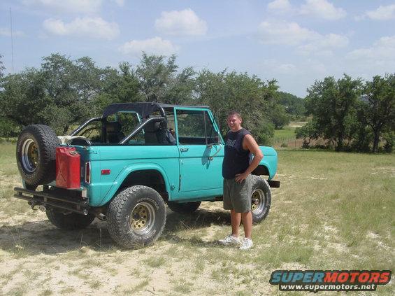 Teal 1973 Ford Bronco with spare tire and gas can on rear bumper