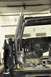 1996 Ford Bronco - A roll cage is being fitted into the interior of a vehicle, showing the bare metal floor and rear structure.