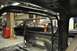 1996 Ford Bronco - The interior of a black pickup truck shows a prominent roll cage, with another black truck visible through the windows.
