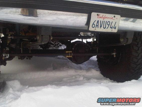 Rear axle and suspension of a vehicle with a California license plate in snow