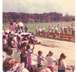 1927 Dodge 1500 - A go-kart is driven on a dirt track during an event with spectators watching.