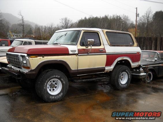 1978 Ford Bronco with two-tone paint, parked outdoors next to another car