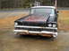 1982 Ford Bronco - A vintage car with a weathered exterior sits parked on the side of the road.