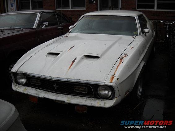 White 1971 Ford Mustang with hood scoops and rust spots