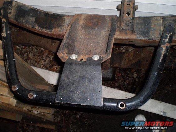 aftermarket trailer hitch receiver attached to a rusty frame
