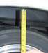 1976 Ford Ranchero - A tape measure is used to check the clearance between a tire and the vehicle's fender.