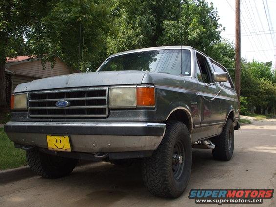 1989 Ford Bronco parked on a street, front 3/4 view
