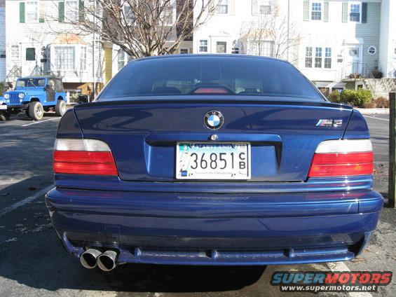 Blue BMW M3 rear with quad exhaust pipes and M3 badge
