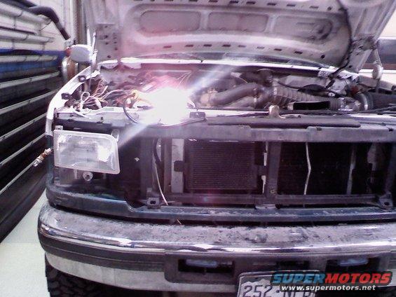 To get the everything off that is off in the pic, the access to the bolts you need is thru a small hole in the core support. behide the headlight assembly.