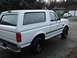 1996 Ford Bronco - A white Ford Bronco is parked in front of a house and garage.