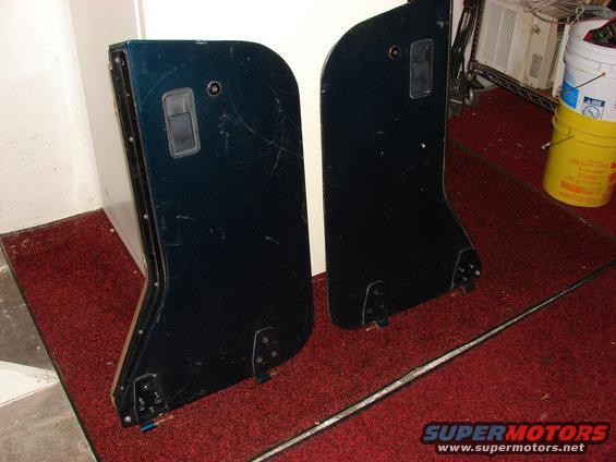Two dark blue Jeep CJ doors leaning against a wall