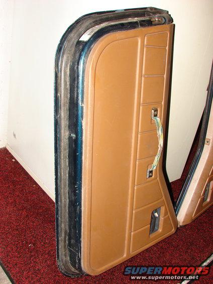 Two tan Jeep CJ door panels with pull handles and window cranks