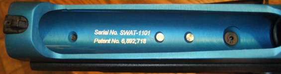 Blue metal part with serial number SWAT-1101 and patent number 6,892,718