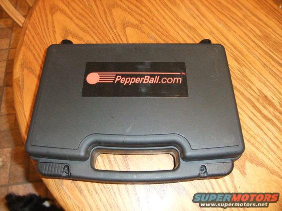Black carrying case with PepperBall.com logo on a wooden table