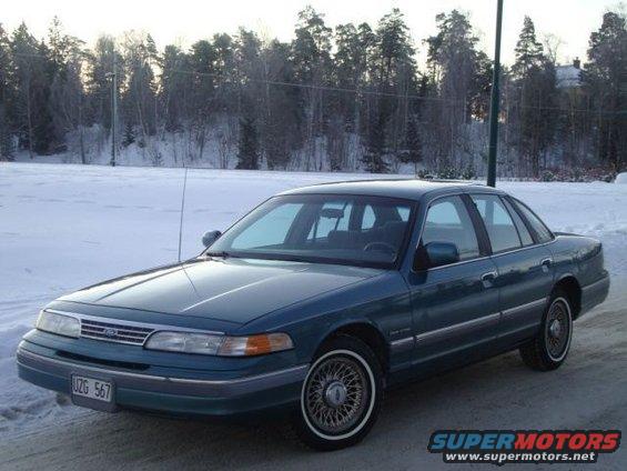 Blue 1993 Ford Crown Victoria parked in a snowy area