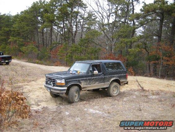 Black 1994 Ford Bronco on dirt road