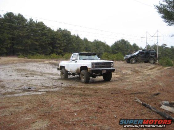 White pickup truck with large tires off-road