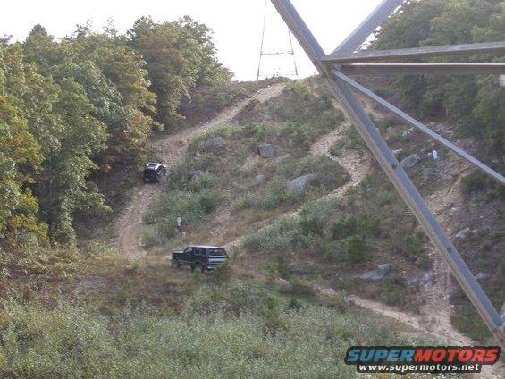 1994 Ford Bronco driving on a dirt trail