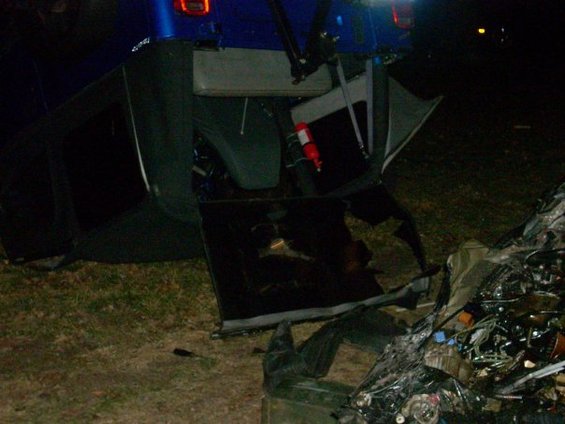 Interior of a wrecked blue SUV, showing seats, a fire extinguisher, and damaged front end